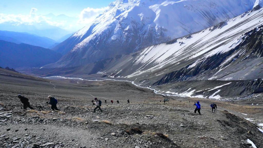 Trekkers trekking on the rugged terrians, on their way to Tilicho Lake.